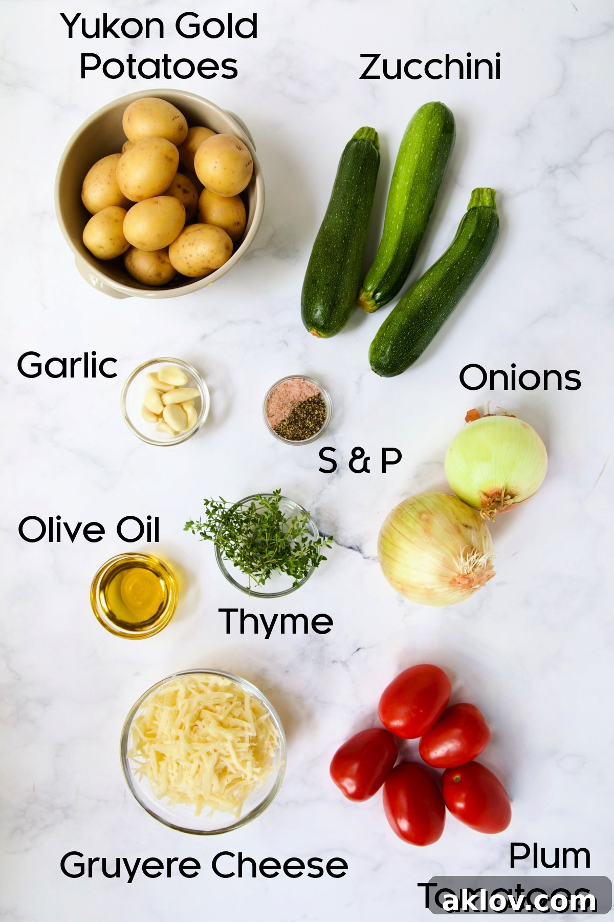 Ingredients for Vegetable Tian on marble countertop.