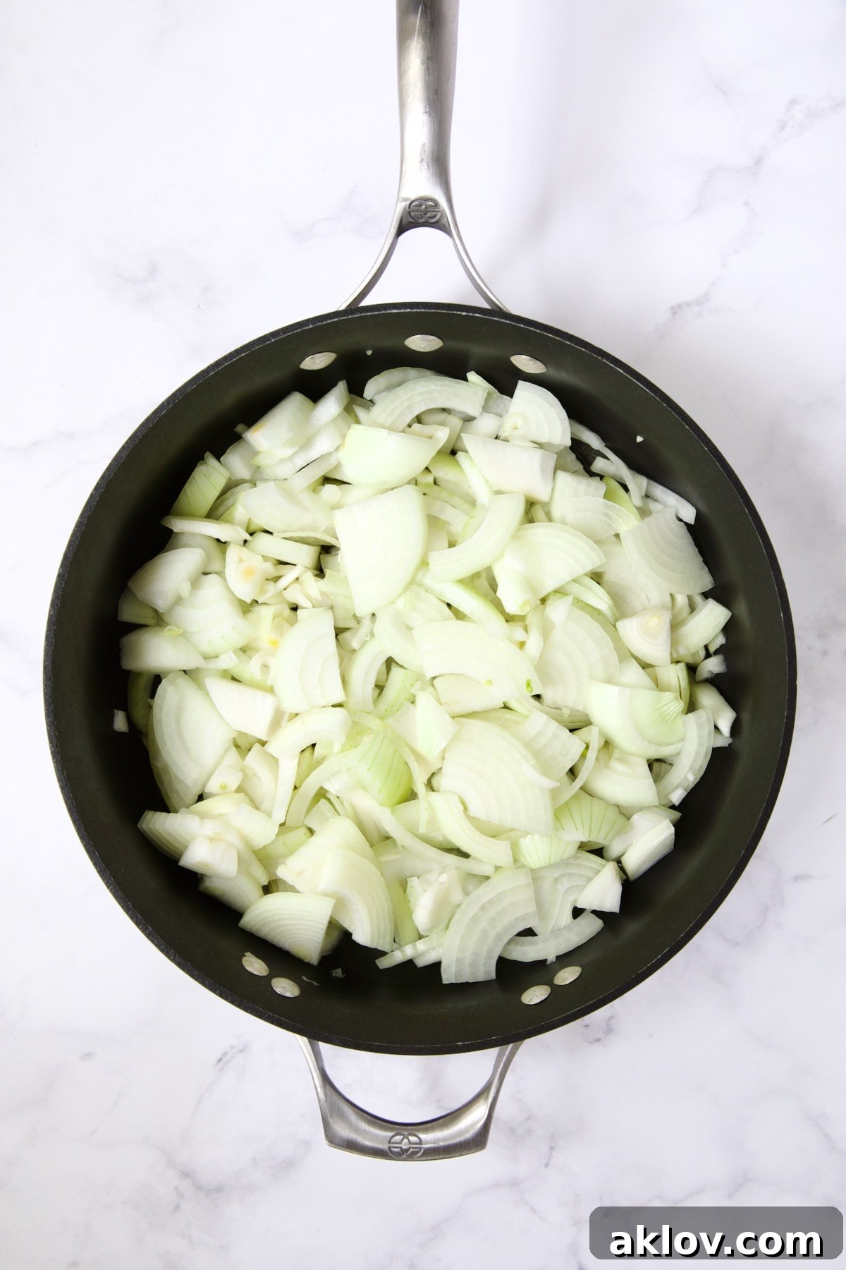 Raw onions in nonstick skillet.