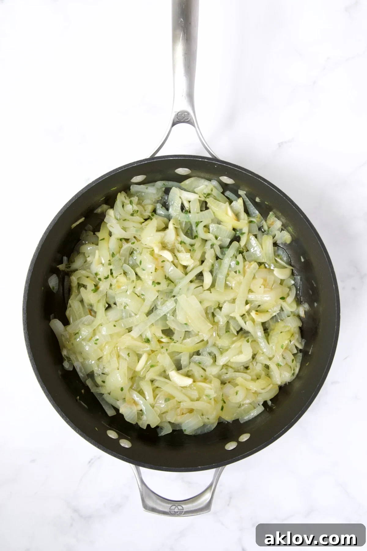 Sautéed onions, garlic, and fresh thyme mixed in a nonstick skillet.