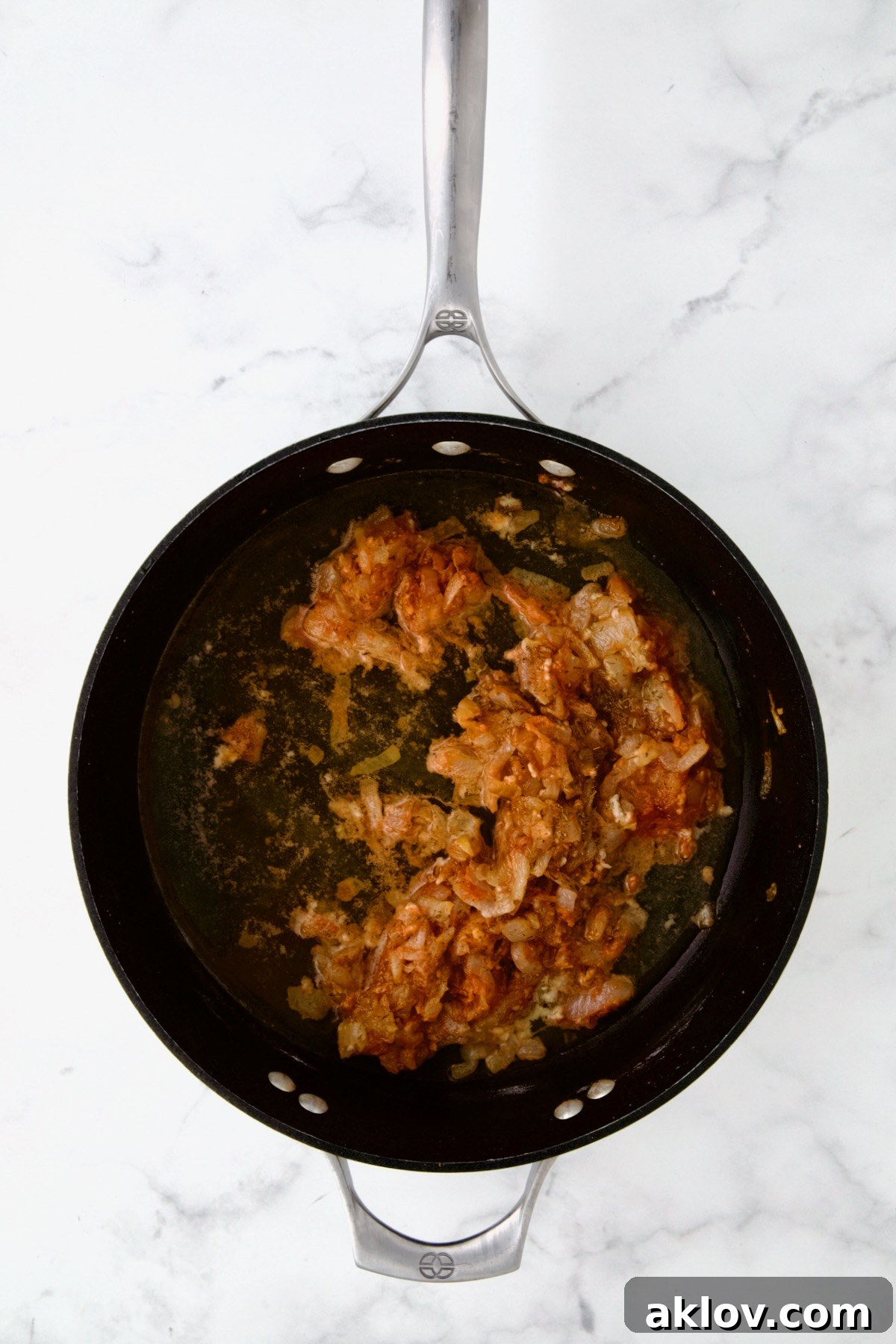 Golden Turkey Meatballs with Ale Glaze 13 Onions and tomato paste in nonstick skillet.