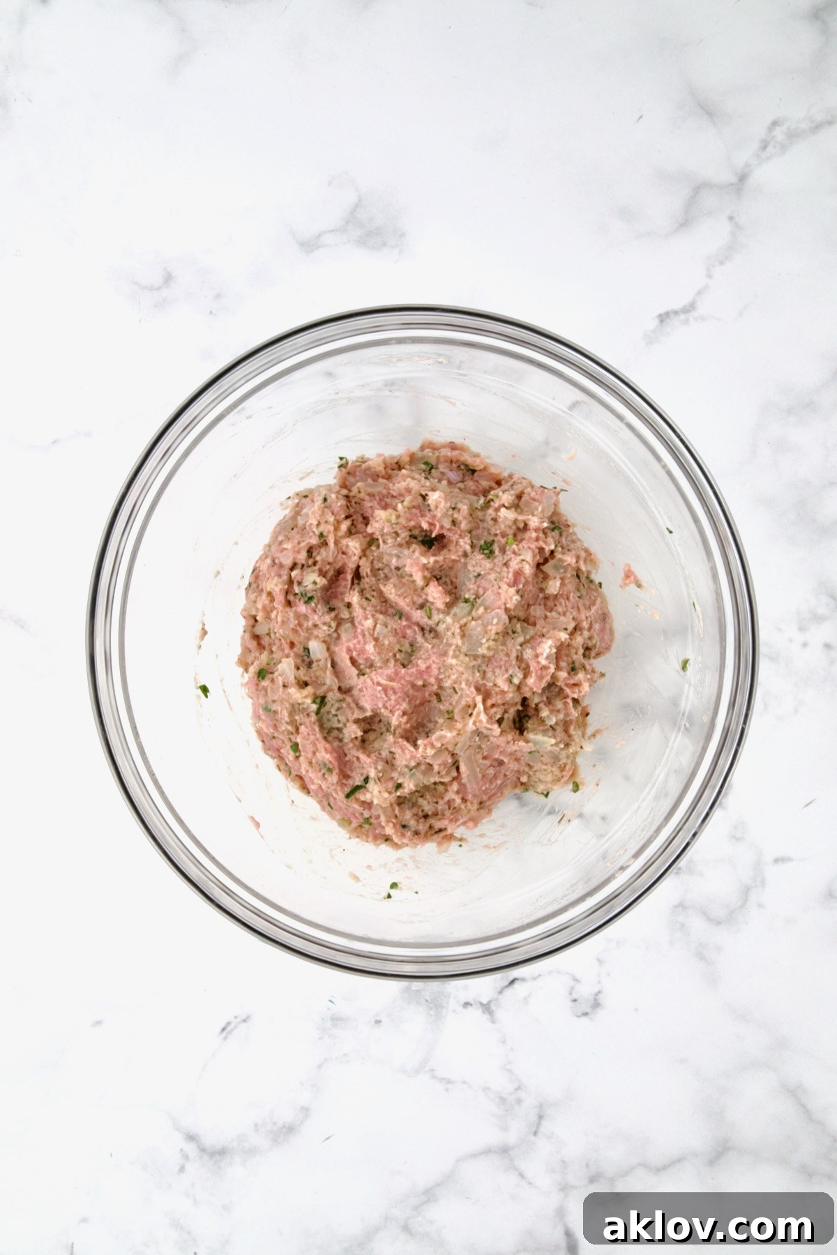 Golden Turkey Meatballs with Ale Glaze 9 Ingredients for turkey meatballs with ground turkey in glass bowl before being mixed together.