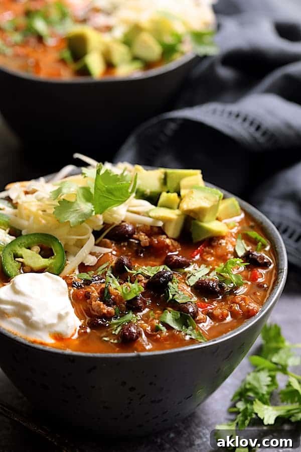 Close-up shot of a single bowl of Turkey Black Bean Quinoa Chili, highlighting its rich texture and colorful ingredients.