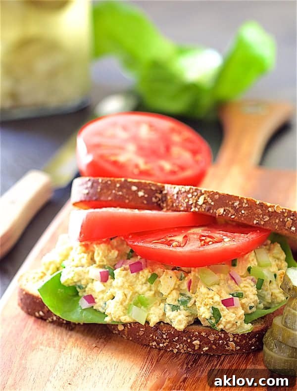 Photo of Curried Tofu Salad on whole grain bread with lettuce and tomato.