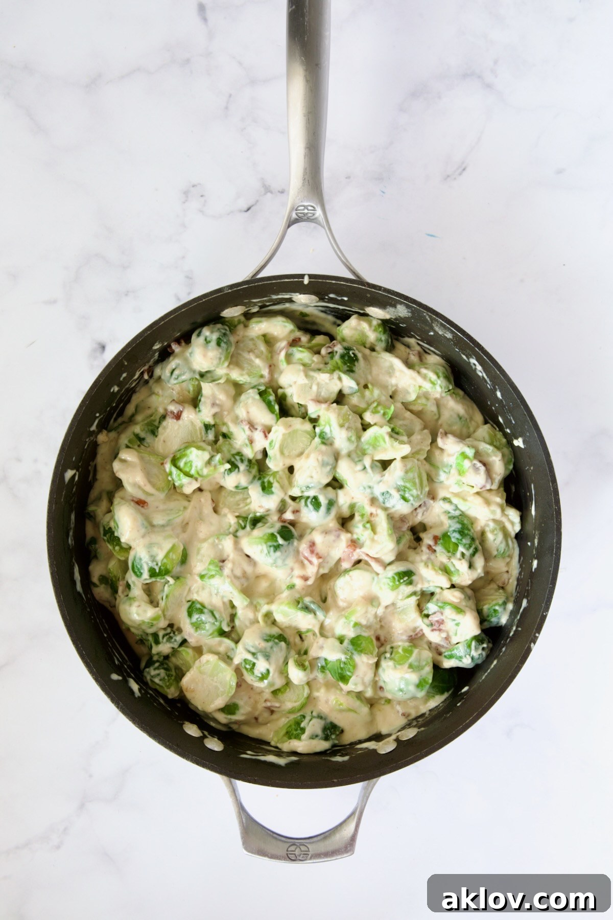 Blanched Brussels sprouts and bacon combined with the cheese sauce in nonstick skillet.