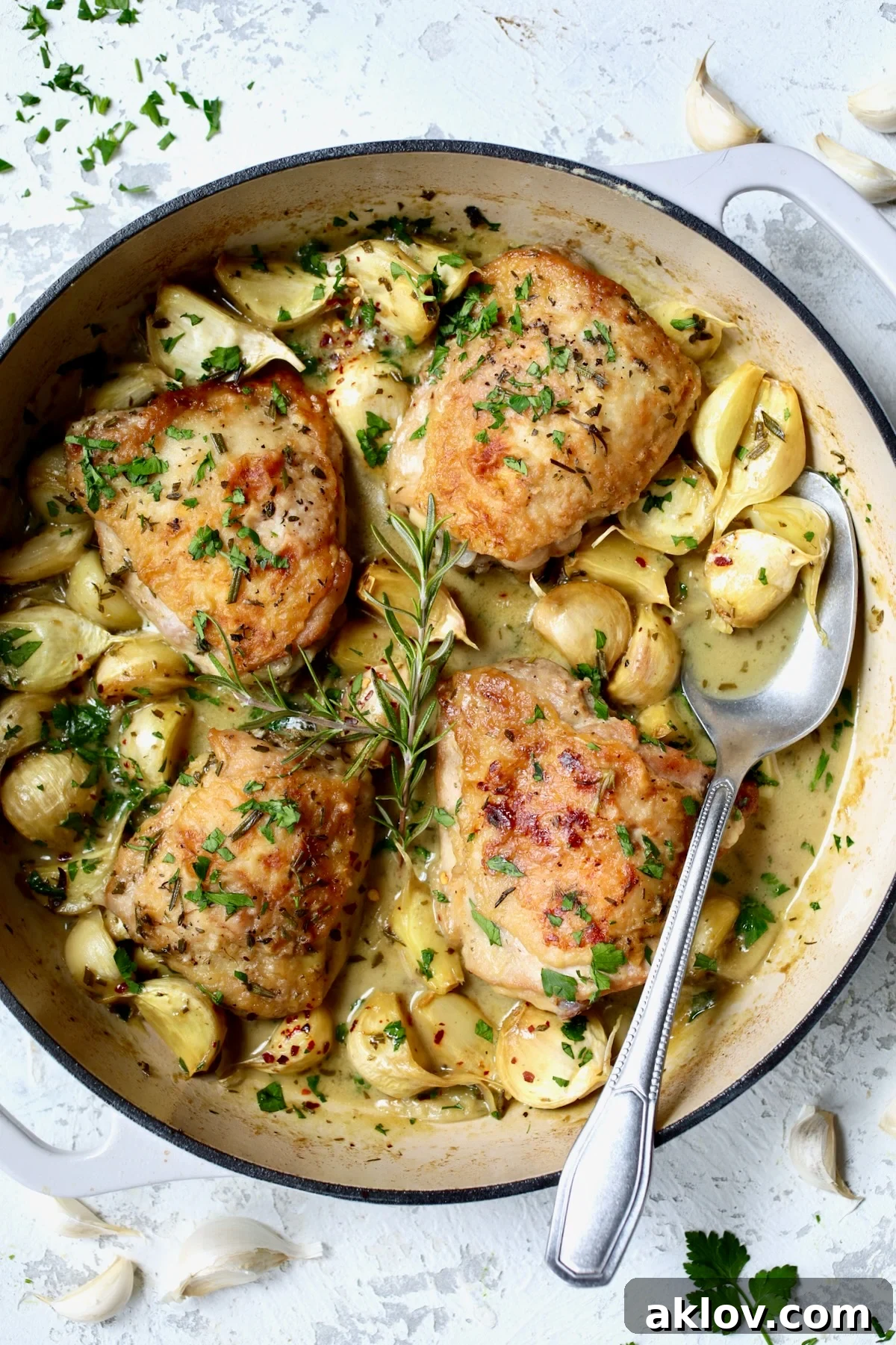 Finished 40 Clove Garlic Chicken in white enamel cast iron skillet.