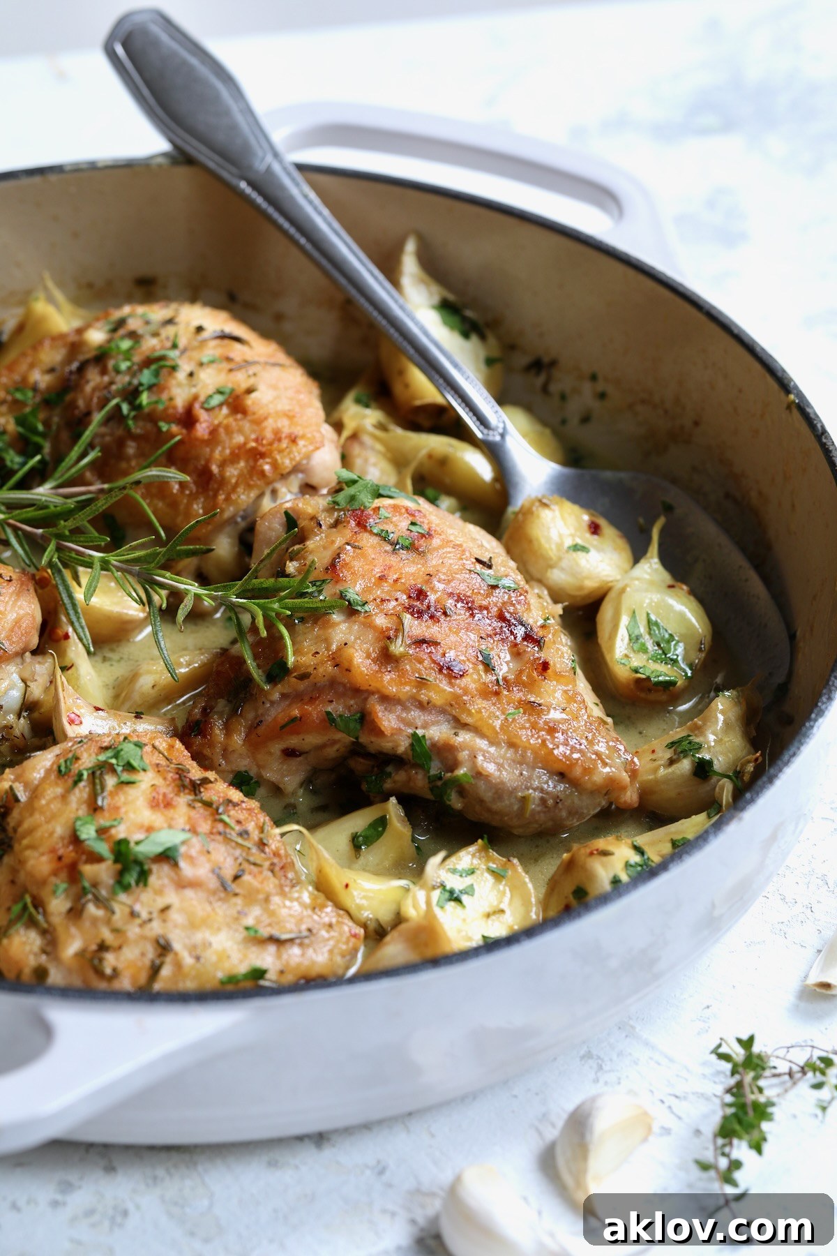 Finished 40 Clove Garlic Chicken in white enamel cast iron skillet.