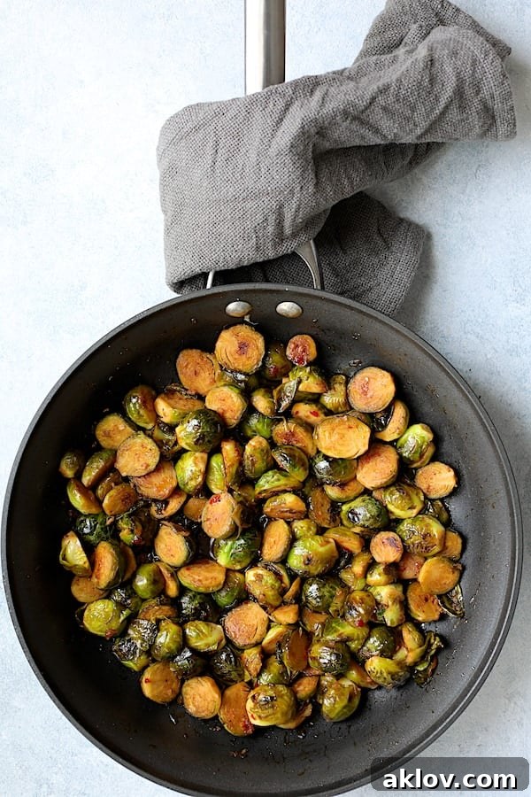 Photo of glazed Brussels sprouts in nonstick skillet.