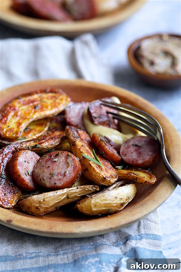 Detailed close-up of Duck Fat and Rosemary Roasted Fingerling Potatoes with Sausage in wooden bowls, highlighting the crispy texture and appetizing colors.