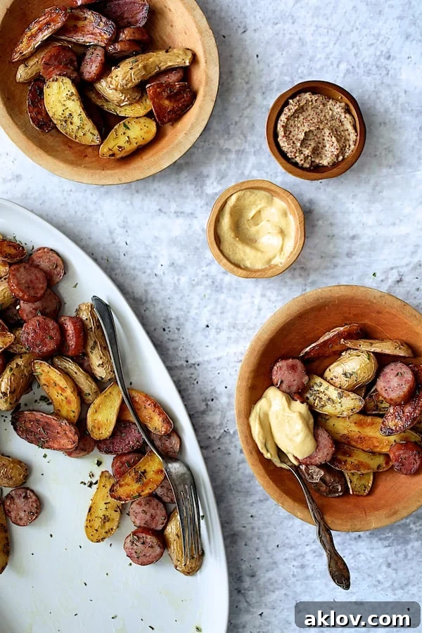 Individual wooden bowls filled with Duck Fat and Rosemary Roasted Fingerling Potatoes and Sausage, showcasing the delightful presentation.