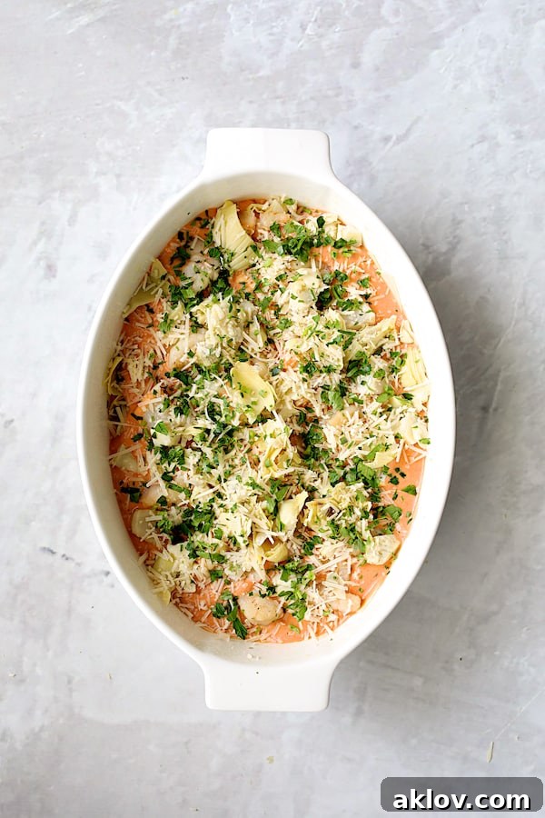 Photo of lasagna with cheese and parsley added.