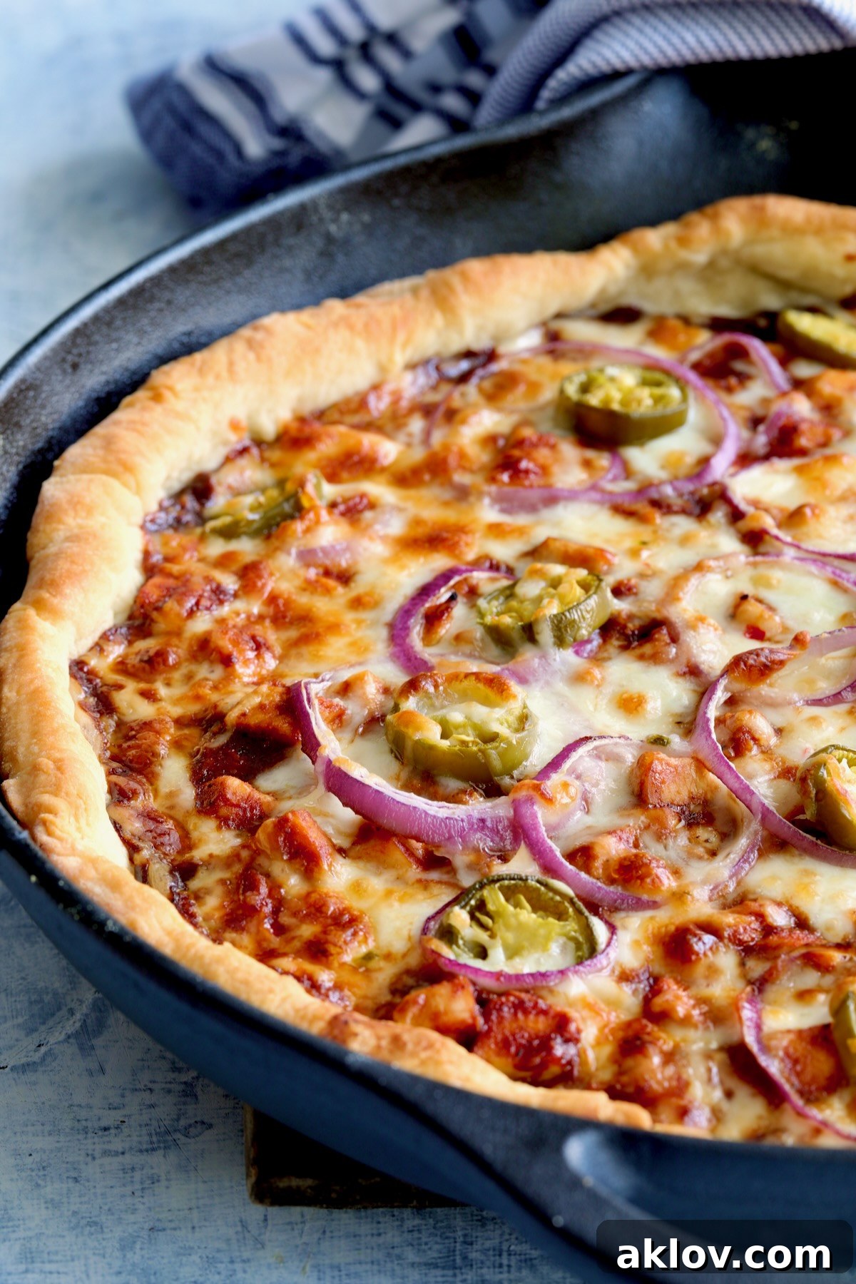 Topped pizza in cast iron skillet after being baked.