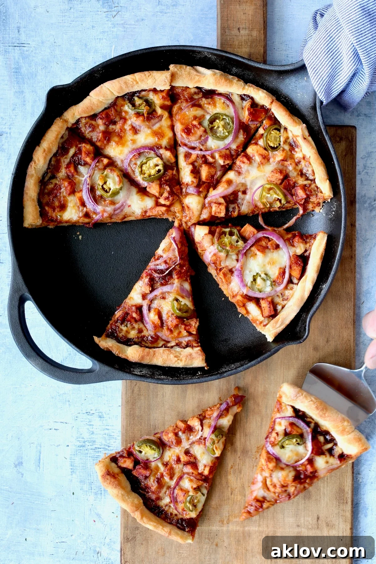 The Cast Iron Skillet Pizza after being baked and expertly cut into wedges, inviting diners to grab a slice.