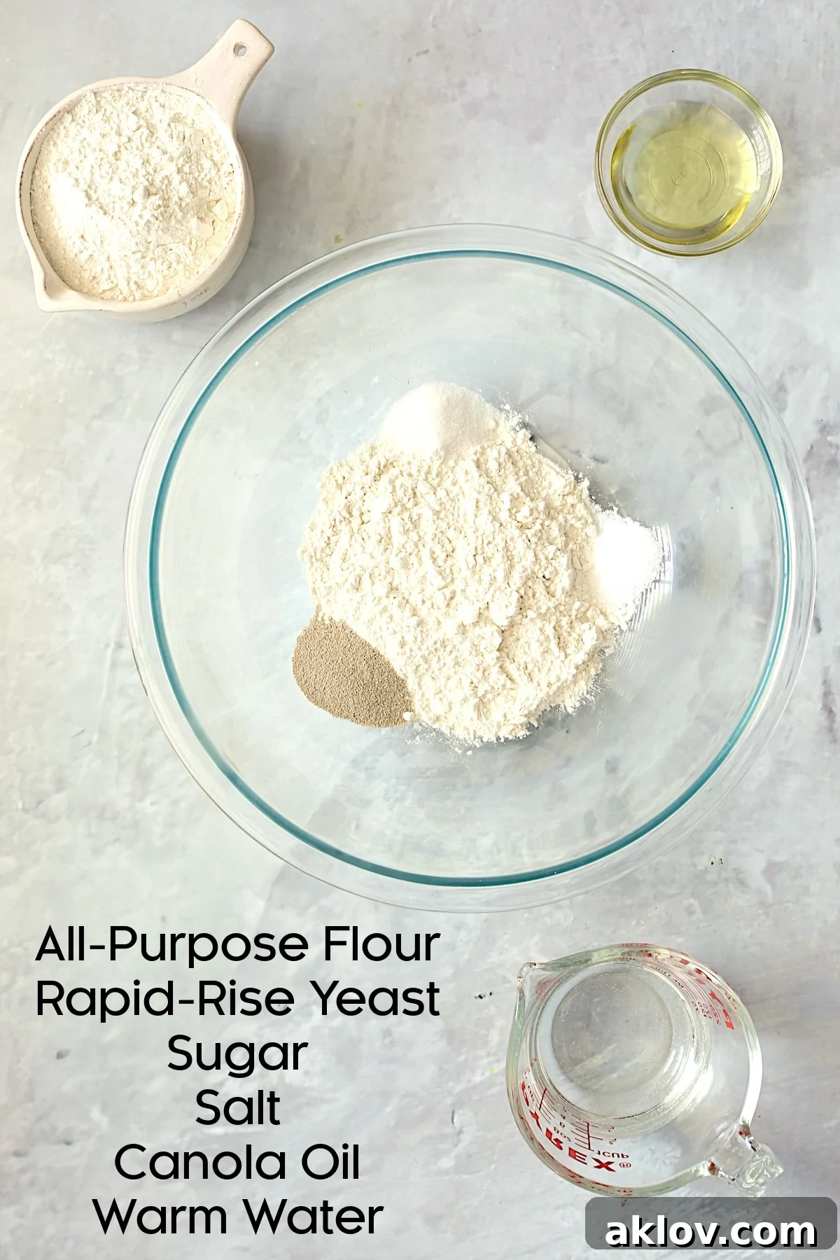 A glass bowl filled with the initial dry ingredients for pizza dough, ready for the liquids to be added.
