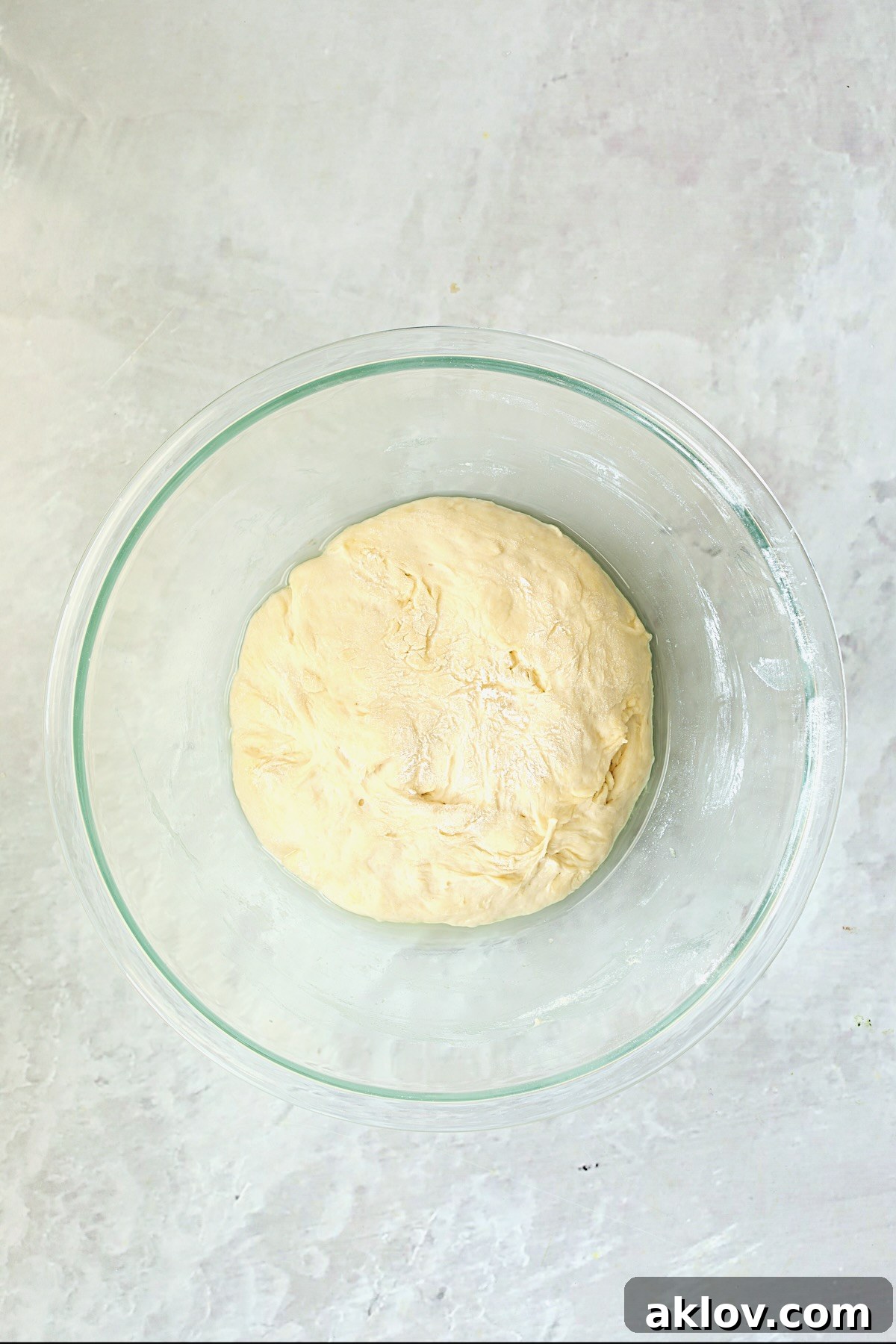 Pizza dough in glass bowl after rising.