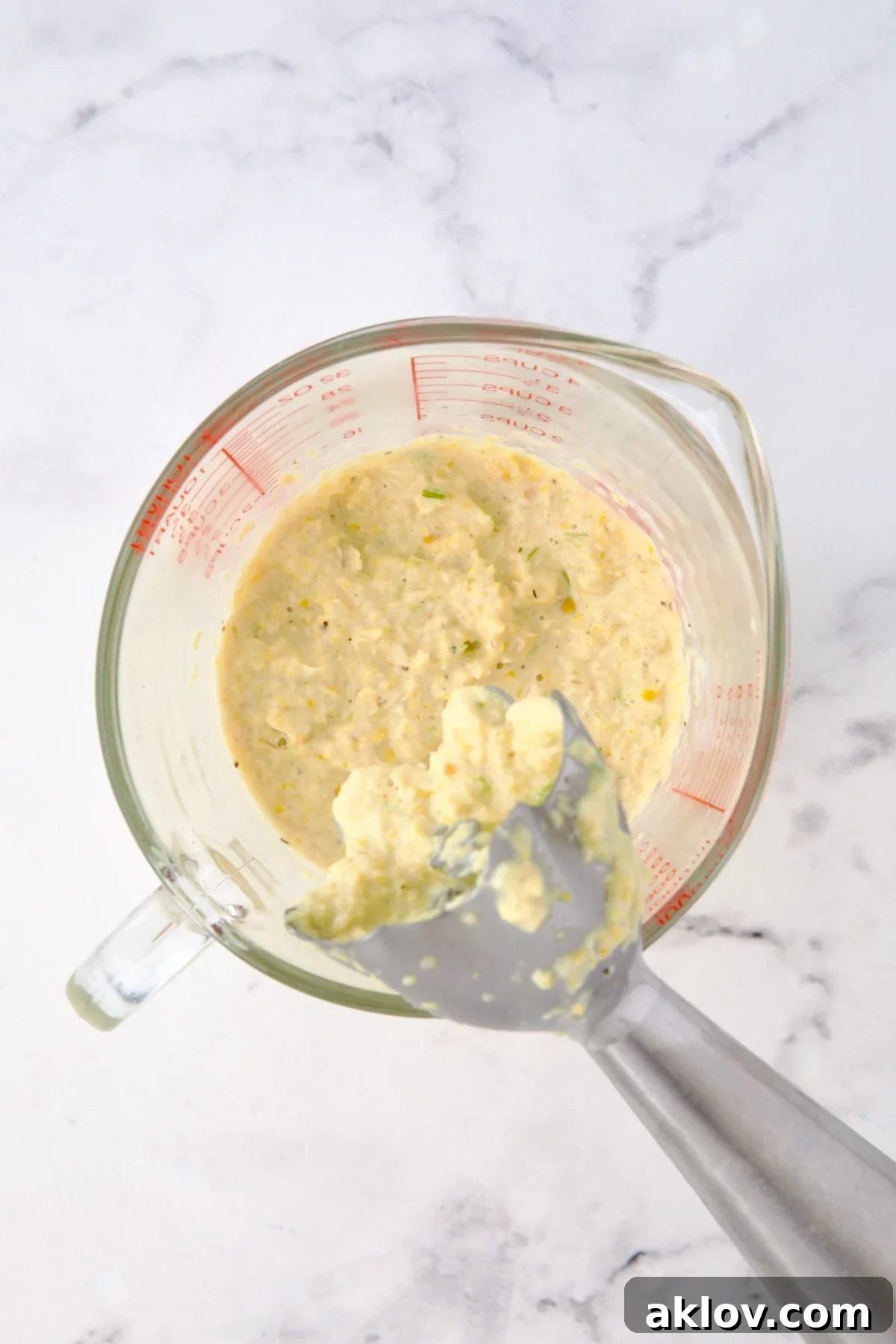 Pureed corn in glass measuring cup.