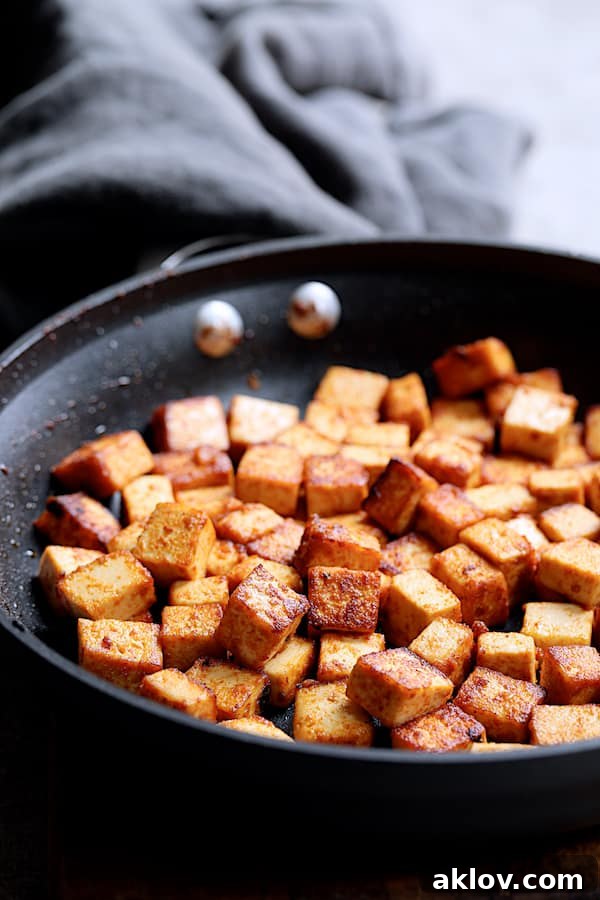 Photo of tofu being browned in nonstick skillet