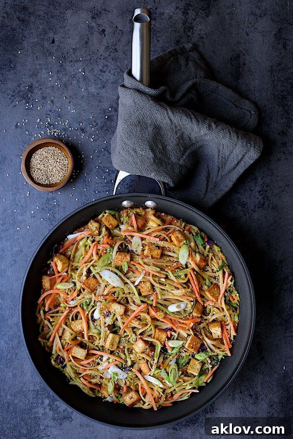 Thai Sesame Noodles with Tofu and Vegetables - Overhead shot of noodles in skillet garnished with sesame seeds
