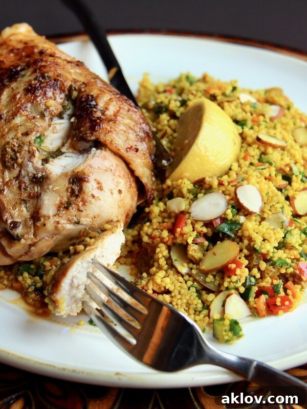 Moroccan Chicken with Jeweled Couscous on white plate.