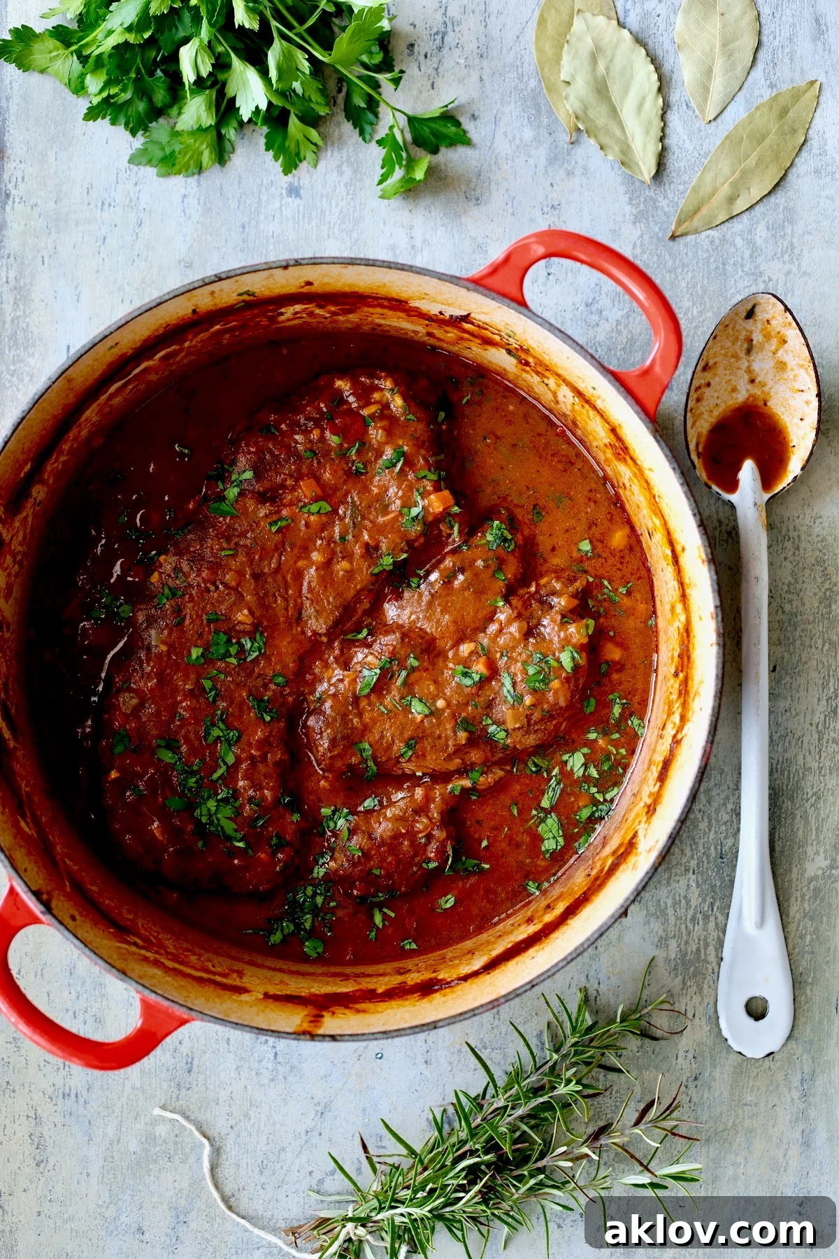 Italian Pot Roast (Stracotto) in red enamel cast iron Dutch oven after being braised.