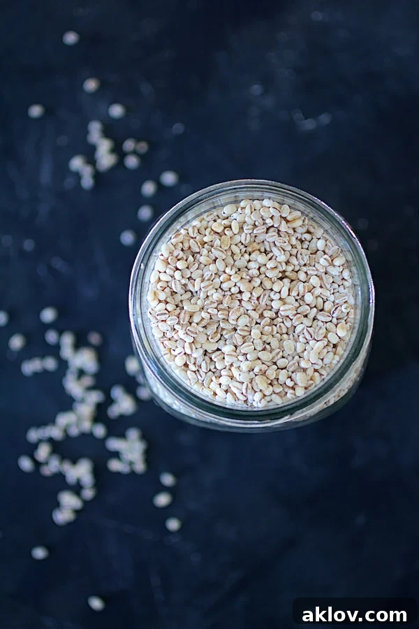 Close-up photo of cooked pearl barley in a glass jar, highlighting its texture.