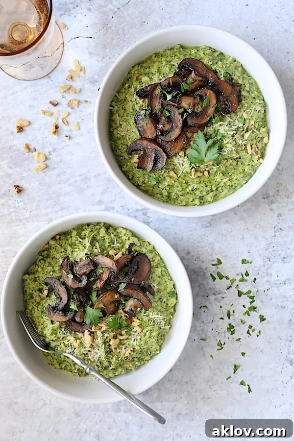 Two servings of Oven Risotto with Kale Pesto and Roasted Mushrooms, elegantly garnished with fresh parsley.