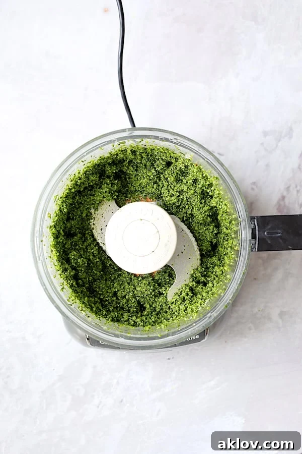 Freshly made kale pesto in a food processor, ready to be incorporated into the risotto.