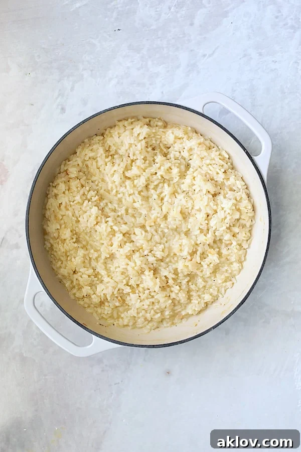 Creamy, perfectly cooked risotto in a cast iron pan, freshly removed from the oven and ready for the final additions.