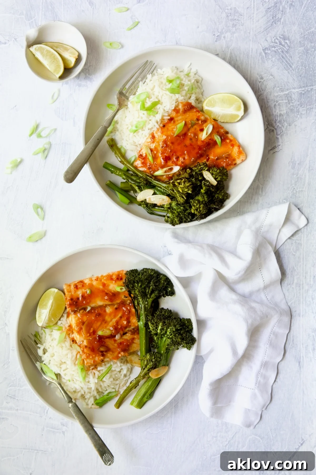 Two servings of Sheet Pan Thai Baked Fish with Broccolini on white plates.