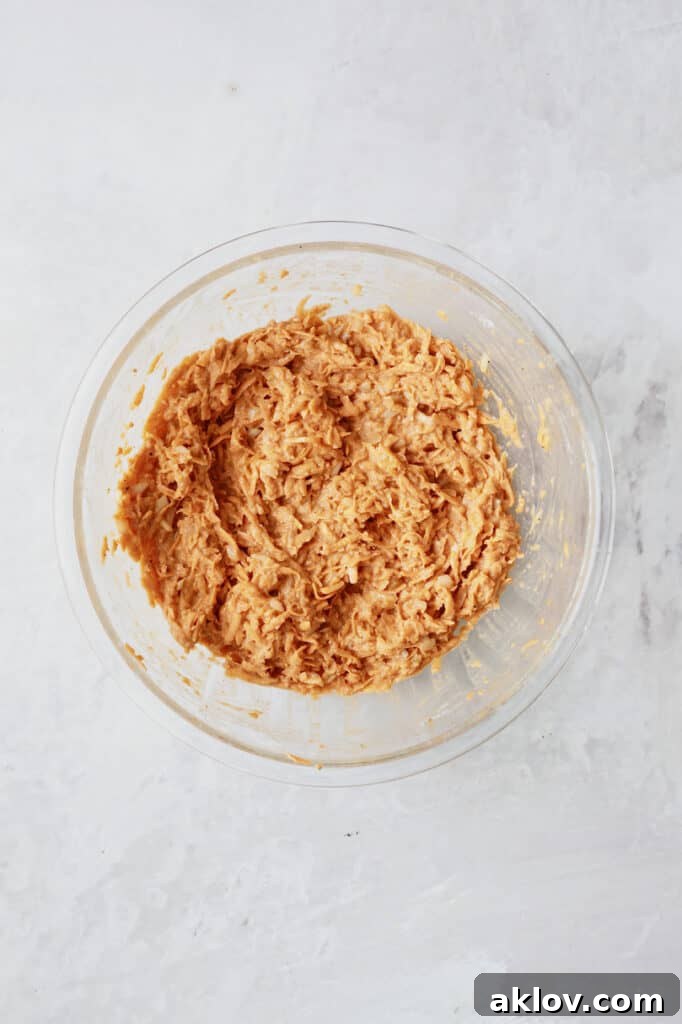 Crispy Sweet Potato Latkes with Fiery Gochujang Aioli 6 Photo of potato combination mixed together in glass bowl.