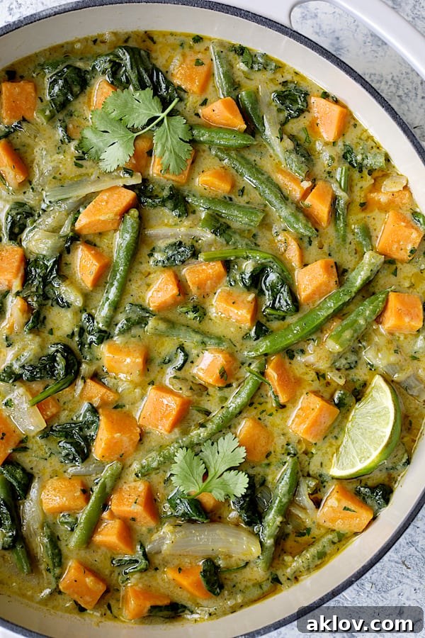 Close-up photo of Vegan Thai Green Sweet Potato Curry in white pan.