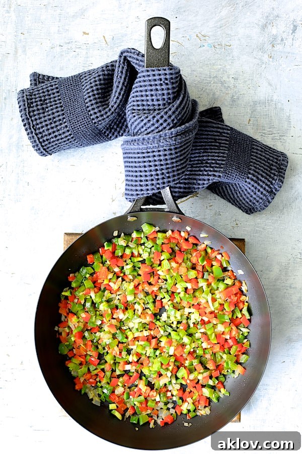 Photo of cooked peppers and onions in skillet.