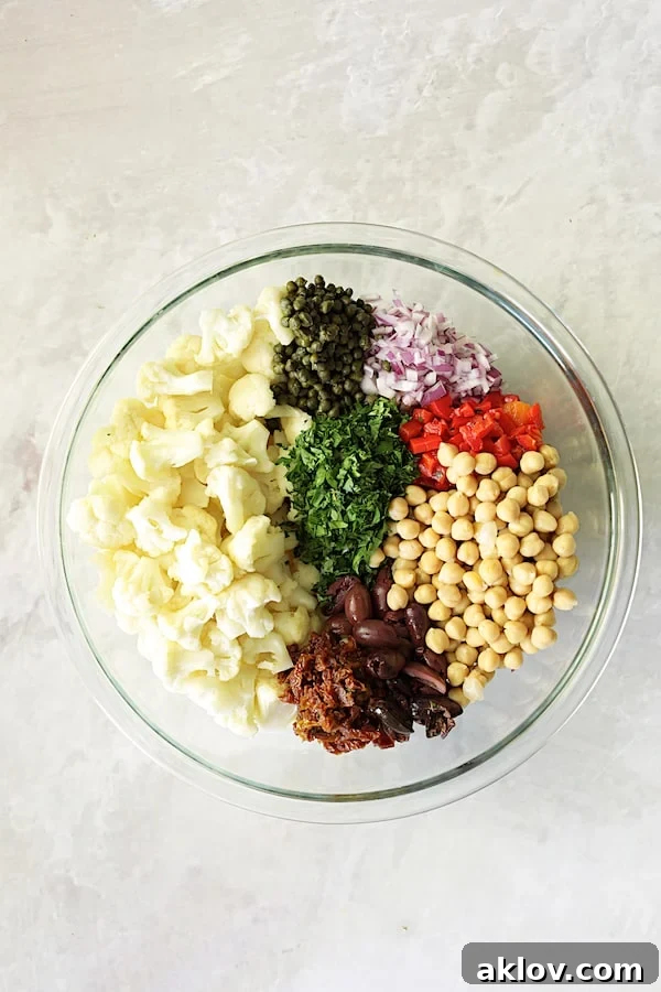 Photo of ingredients for Sicilian Cauliflower Salad in glass bowl.
