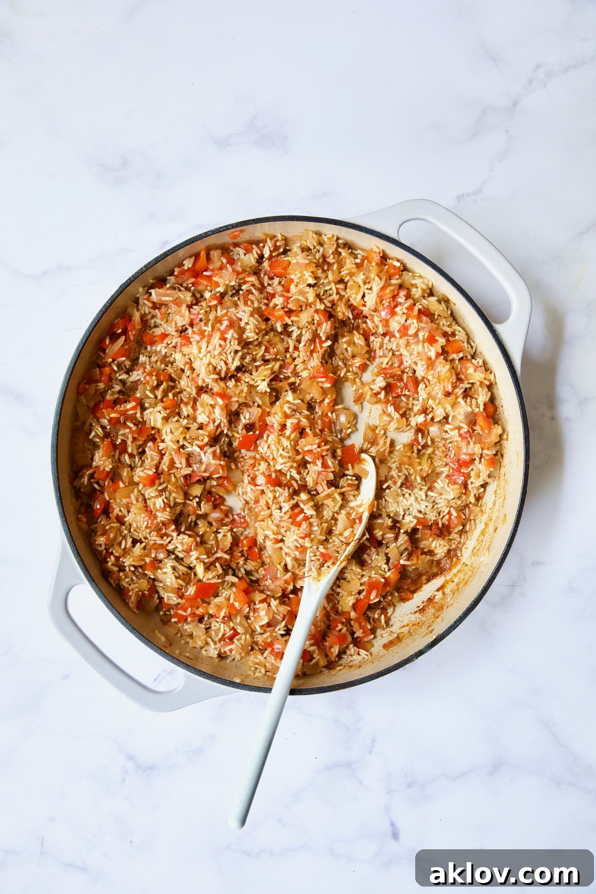 Process shot with rice added to vegetables, absorbing the rich flavors.