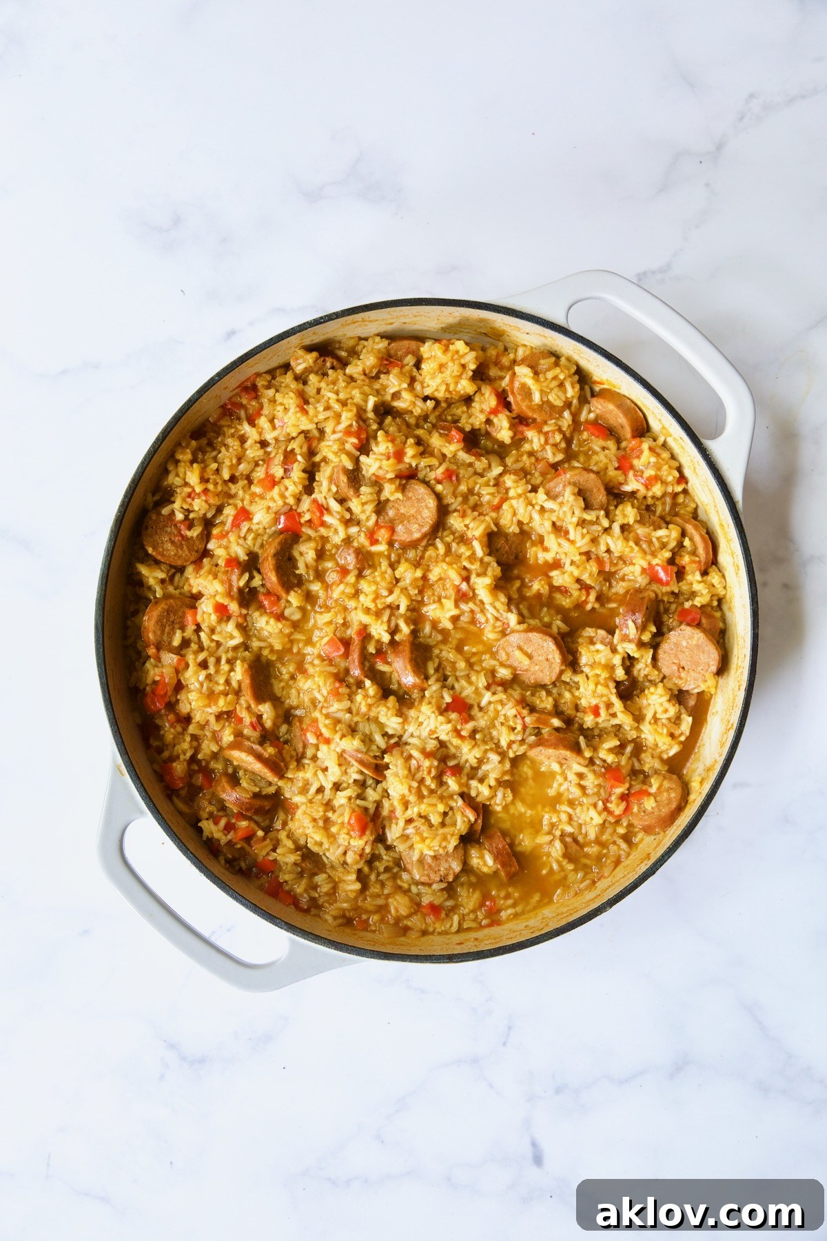 Process shot with rice cooked in the paella, absorbing flavors and liquid.