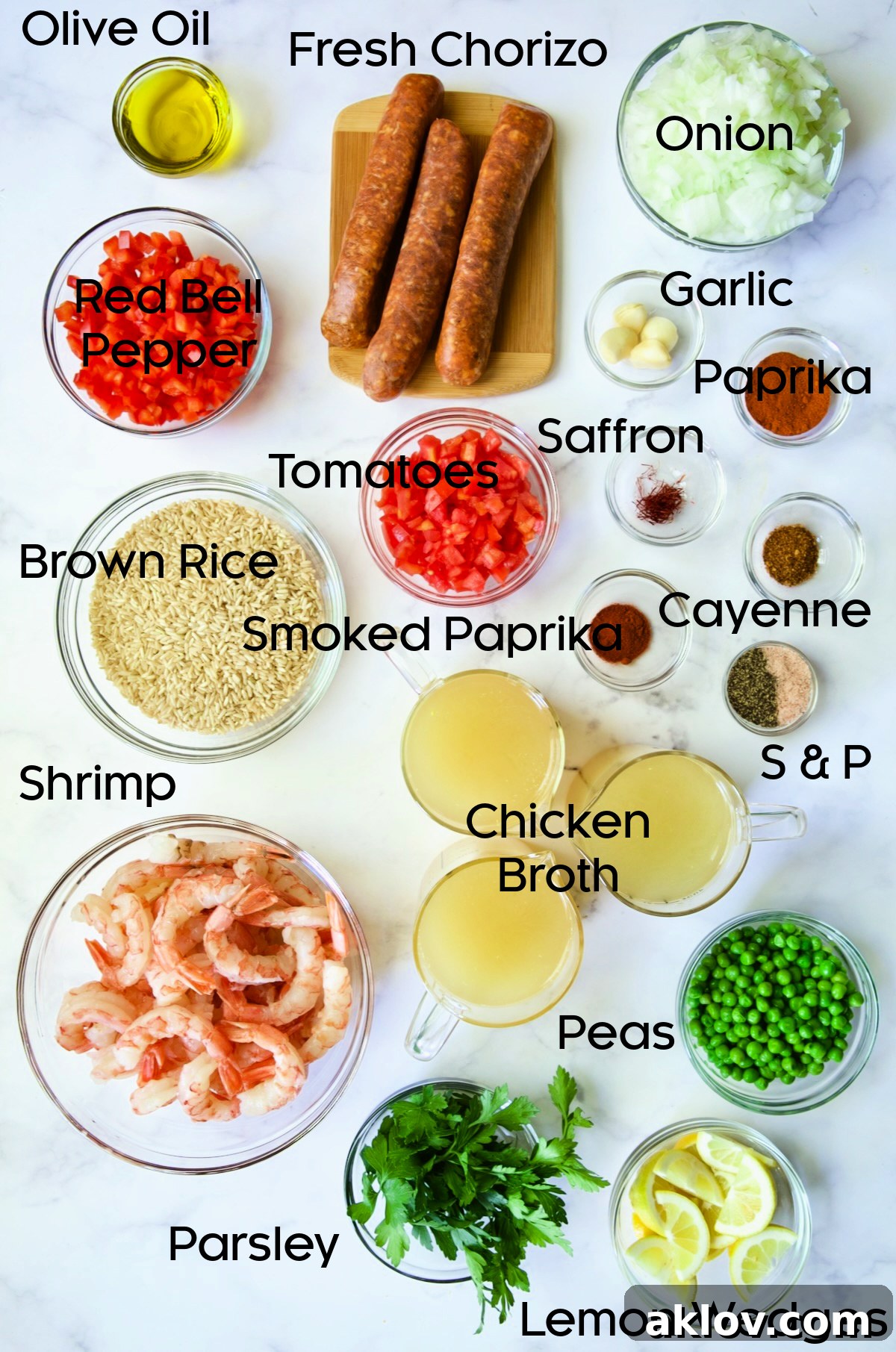 Ingredients for Brown Rice Paella with Shrimp and Chorizo in glass bowls.