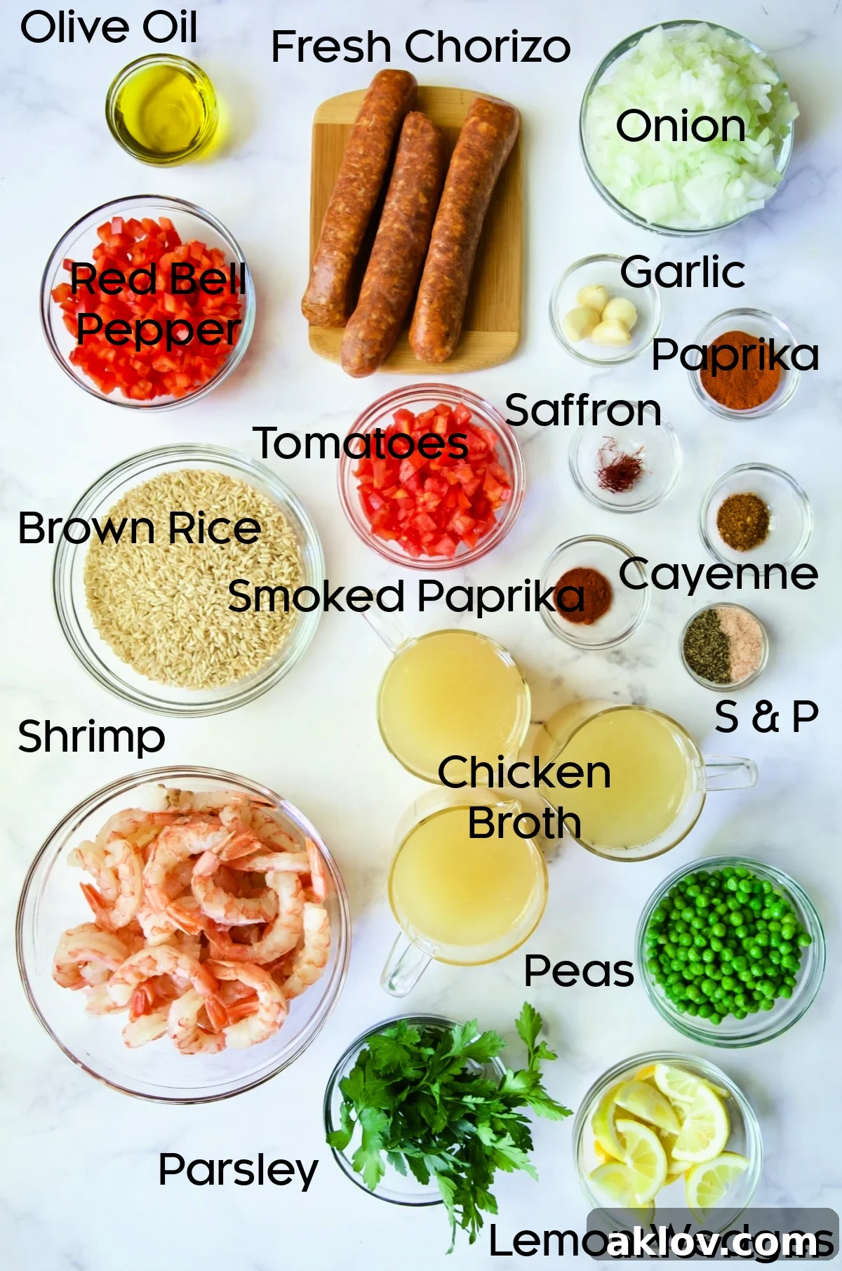 Ingredients for Brown Rice Paella with Shrimp and Chorizo arranged in glass bowls.