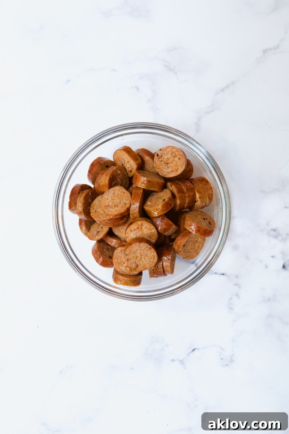 Cooked sliced chorizo in glass bowl.