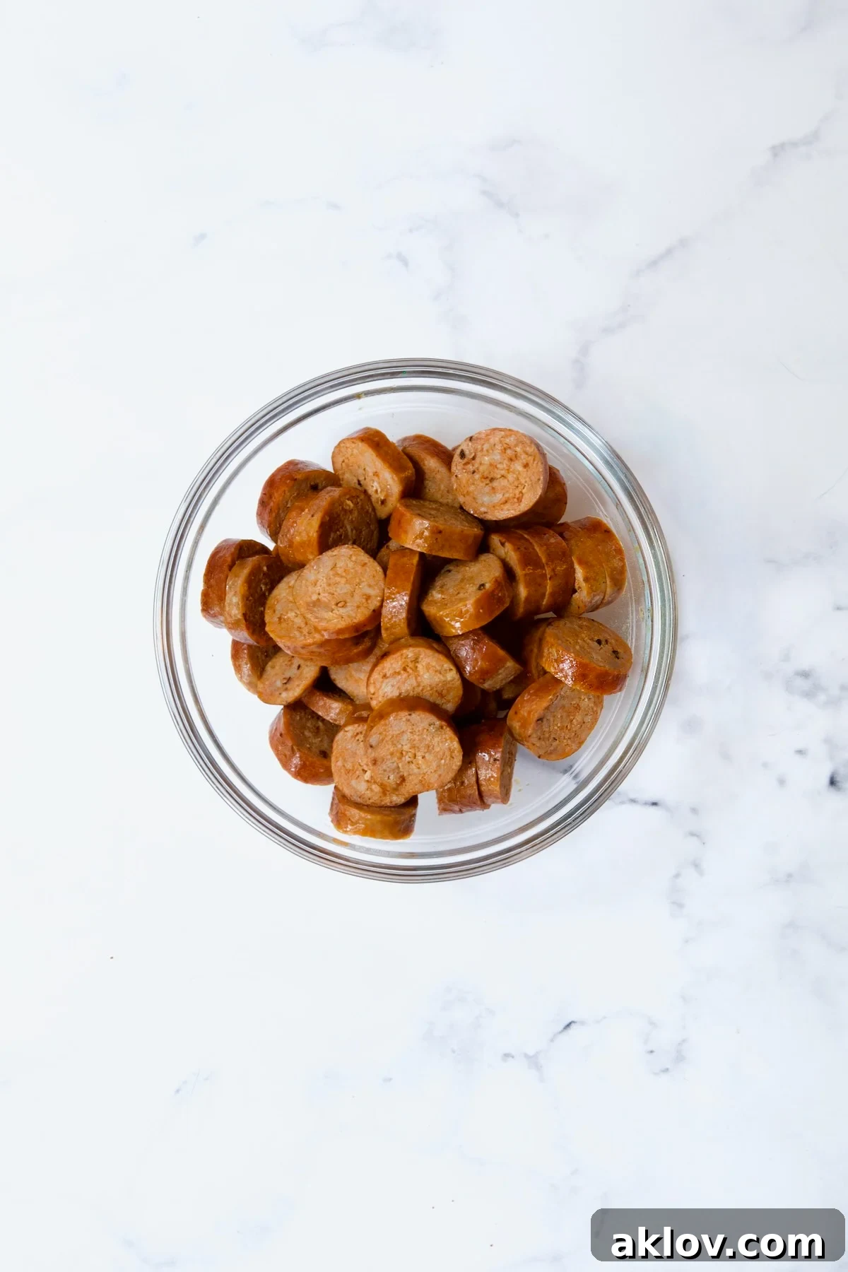 Cooked sliced chorizo in glass bowl, ready to be added back to the paella.