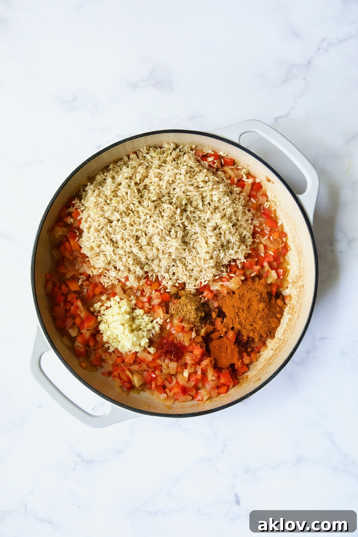 Process shot with brown rice, garlic and spices added to the skillet, stirring to coat.