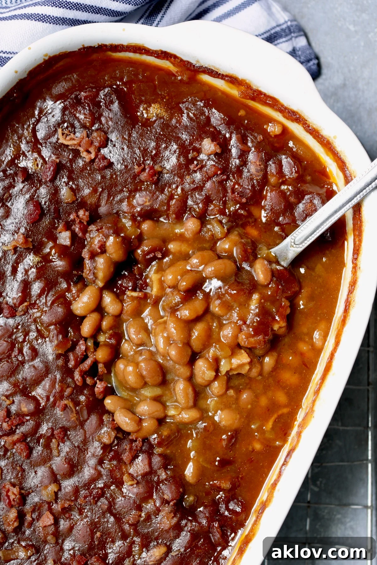 Spoonful of Kicked-Up Canned Baked Beans on serving spoon.