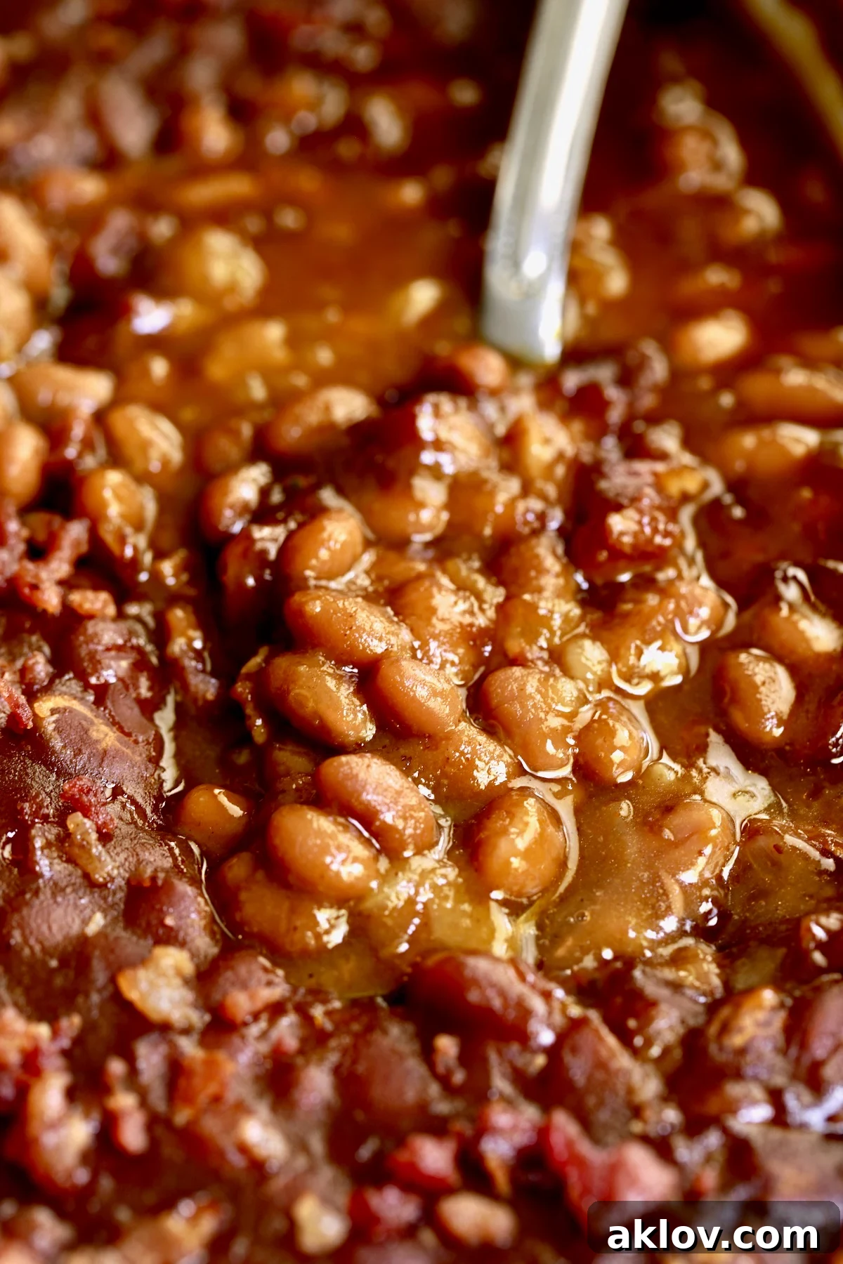 Baked beans on serving spoon.
