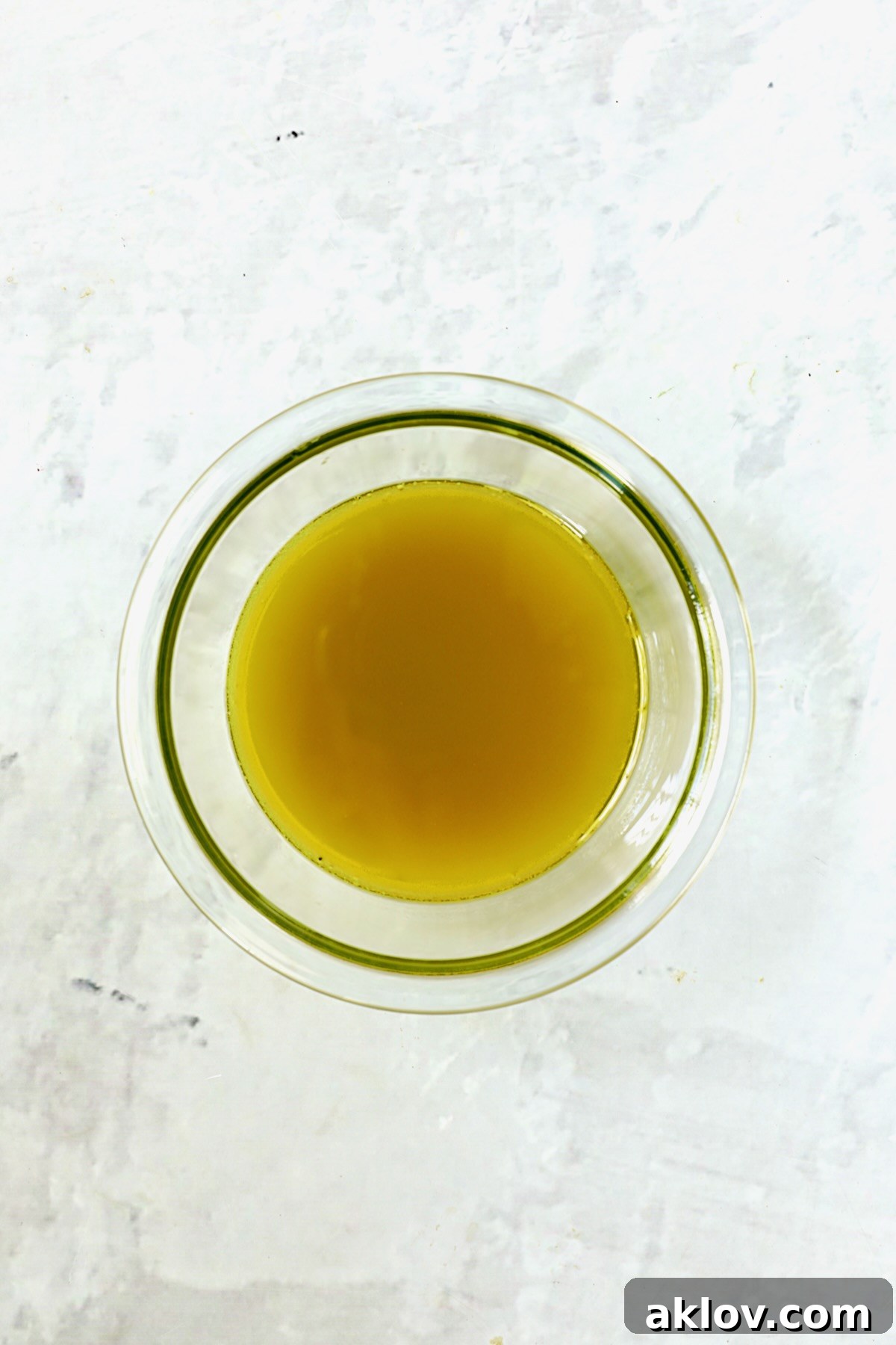 A vibrant, emulsified dressing for French Potato Salad in a small glass bowl, ready to be added to the potatoes.