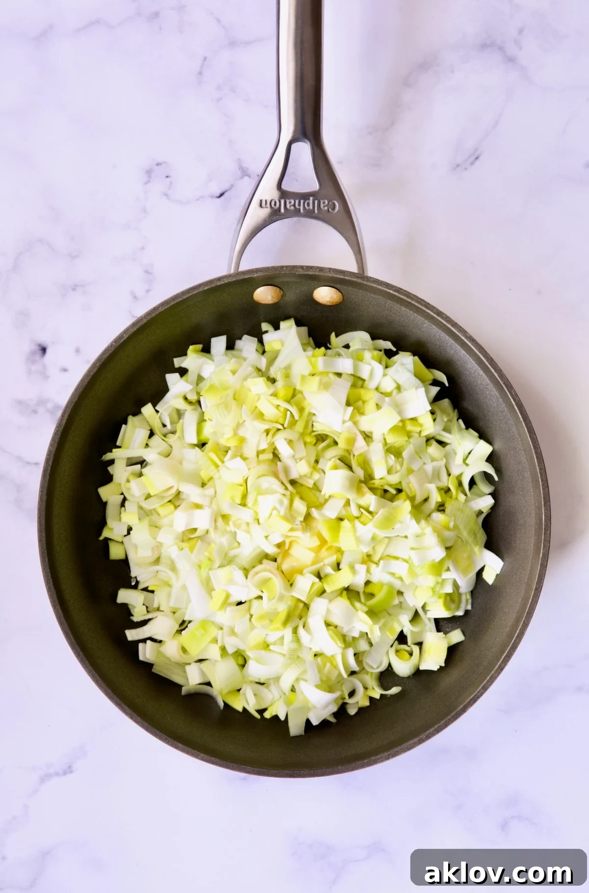 Uncooked leeks in nonstick skillet.