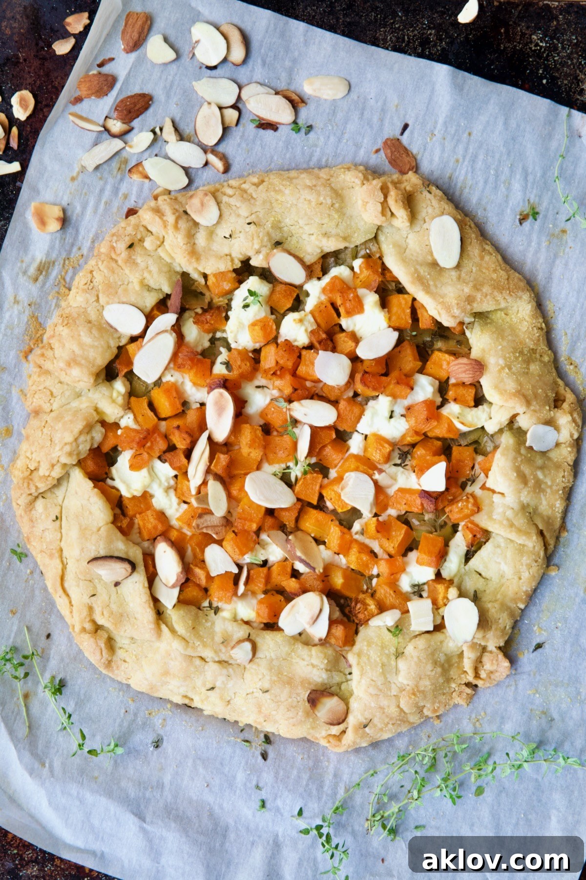A glorious, freshly baked Butternut Squash, Leek, and Goat Cheese Galette, with a perfectly golden crust and bubbling filling, awaiting its first slice.