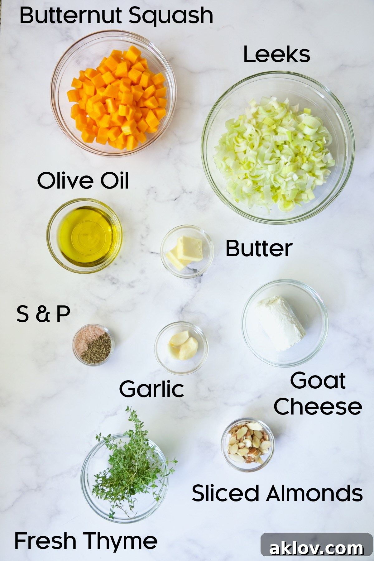 All the vibrant fresh ingredients for the Butternut Squash, Leek, and Goat Cheese Galette filling, neatly arranged in glass bowls and ready for preparation.