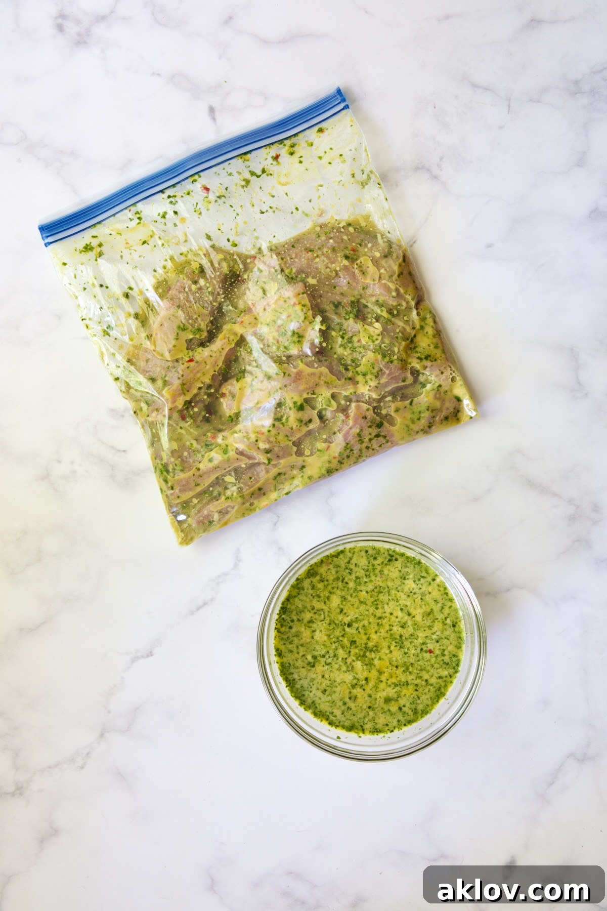 Pork tenderloin strips marinating in a plastic zipper-top bag next to a bowl of reserved dipping sauce.