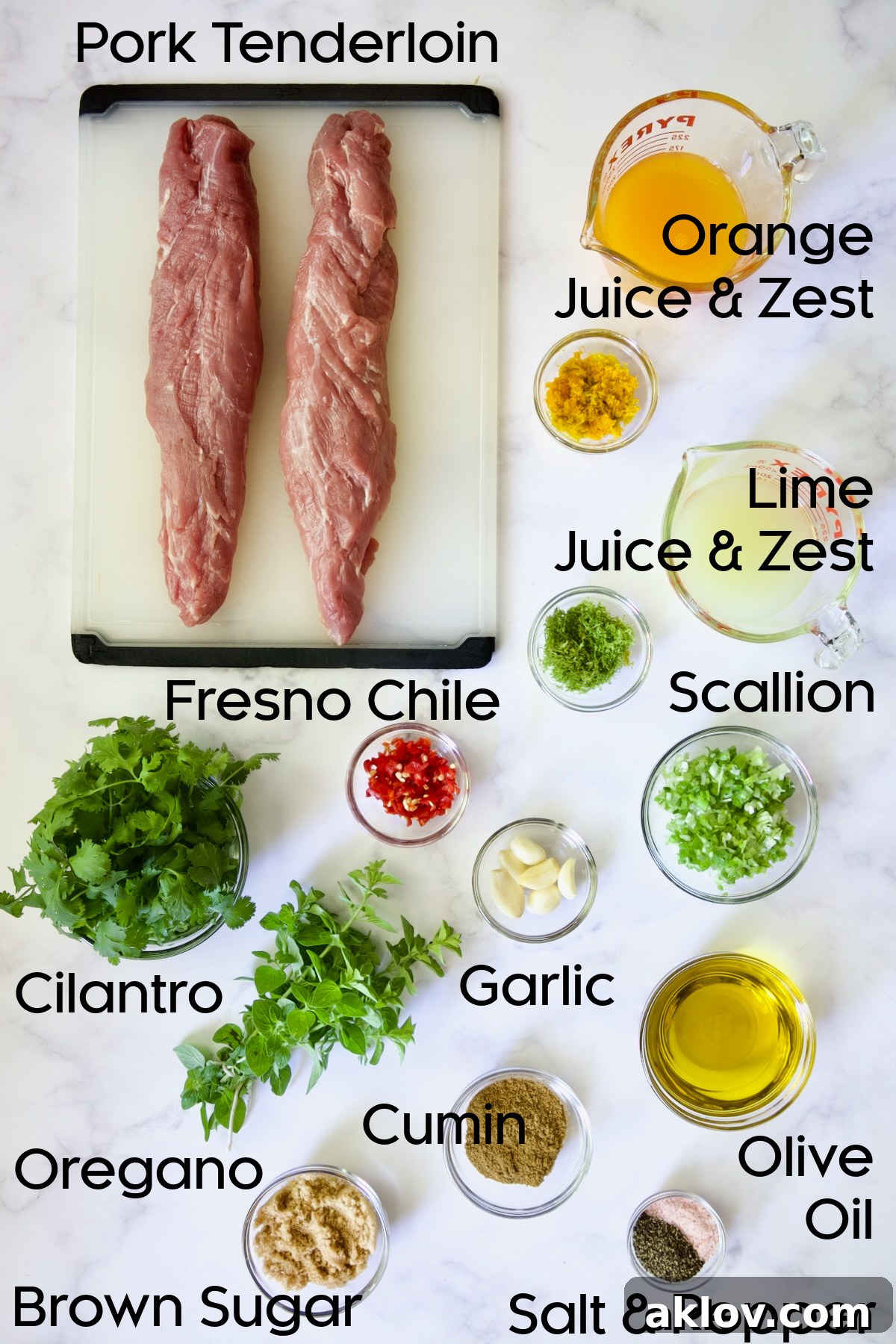 Assortment of fresh ingredients for Mojo-Marinated Pork Skewers displayed in glass bowls.