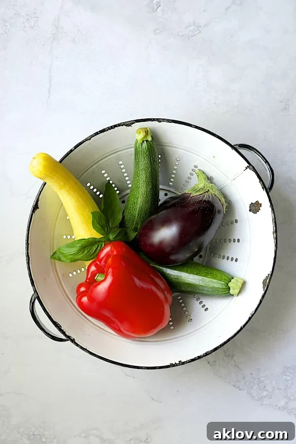 Photo of vegetables for tart in white colander.