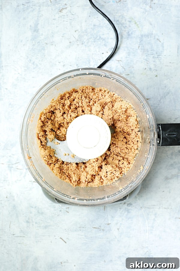 Red lentils being transformed into a thick, spicy puree in a food processor, forming the base for the fritters.