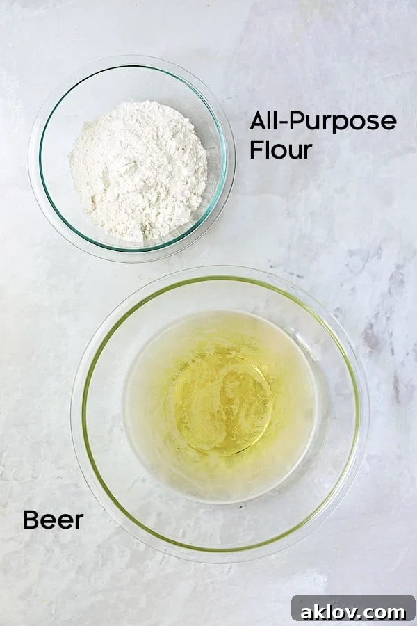 Glass bowls containing the two simple ingredients for beer batter: all-purpose flour and beer.